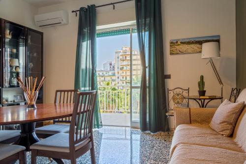 a living room with a table and a couch at AliceA apartment in Siracusa in Siracusa