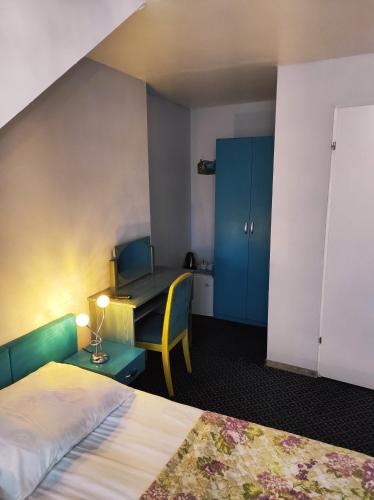a hotel room with a bed and a table and a desk at Pod Różą B&B in Ustka