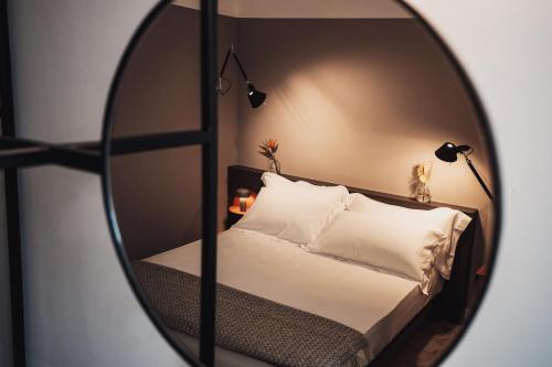 a bedroom with a bed and a mirror at Volante Urban Design Hotel in Santeramo in Colle