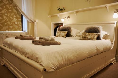 a large bed with stuffed animals on top of it at Southcot Place, Apartment With Garden in Bath