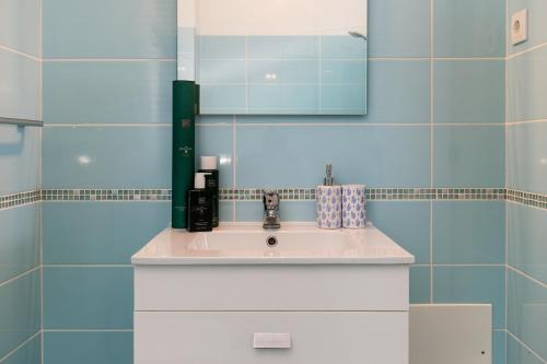 a bathroom with a sink and a mirror at Typical Fisherman's Cottage with amazing sea views! in Albufeira
