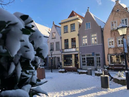 a city street covered in snow with buildings at Radisson Blu Hotel Bremen in Bremen