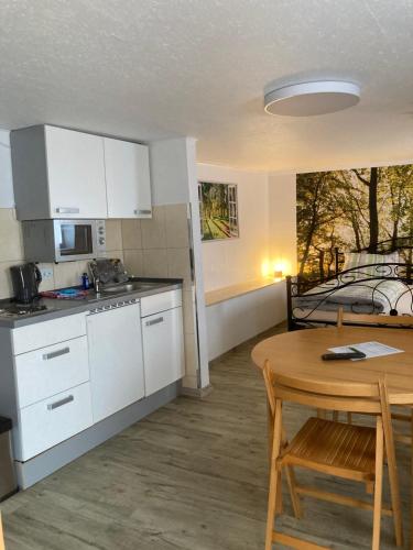 a kitchen and dining room with a table and a table and chairs at HeiSa in Bitzen