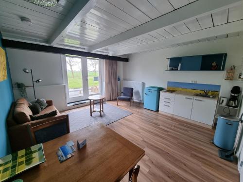 a living room with a couch and a table at B&B de Hugt in Ulrum