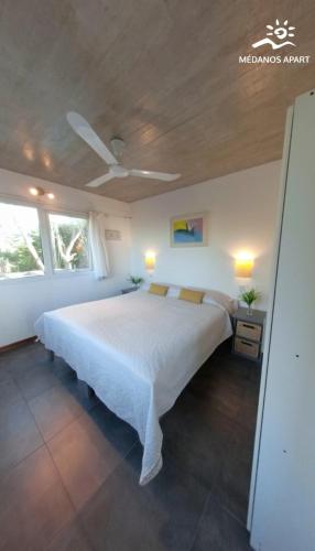 a bedroom with a large white bed in a room at Medanos in Las Gaviotas