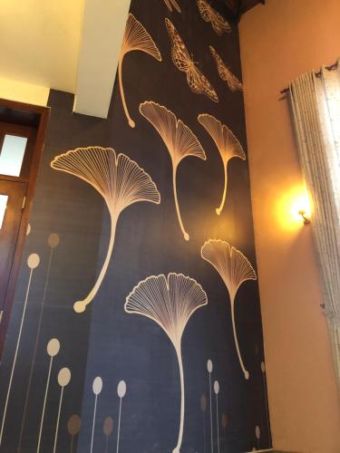 a wall with a painting of white mushrooms on it at THE EDGWARE in Nuwara Eliya
