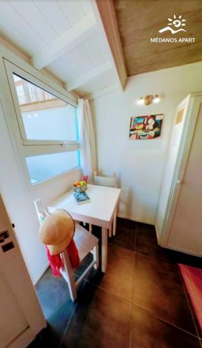 a small room with a table and a window at Medanos in Las Gaviotas