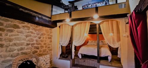 a bedroom with a bed in a stone wall at La Casa del Ayer in Ábalos