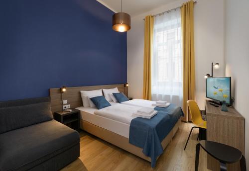 A bed or beds in a room at RES City Residence Hotel Budapest