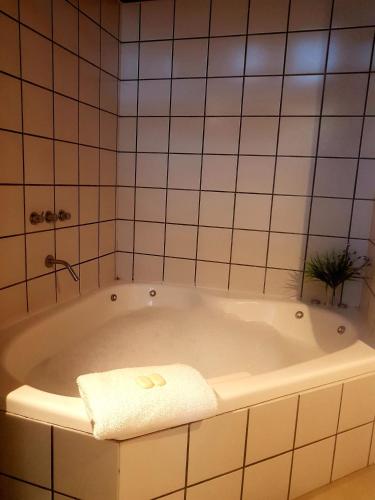 a bathroom with a tub with a towel on it at Medanos in Las Gaviotas