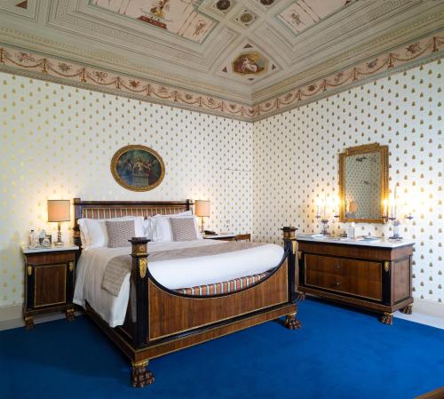 a bedroom with a large bed and two night stands at Villa Abbondanzi Resort in Faenza