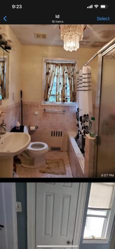 a bathroom with a sink and a toilet and a window at Royalbluecozy in Saint Albans