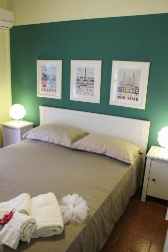 a bedroom with a bed with two towels on it at Retrò Rooms in Cefalù