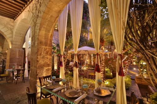 a dining room with a table in a building at Hotel De La Soledad in Morelia