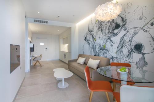 a living room with a couch and a glass table at ESTIMAR Calpe Suitopia in Calpe