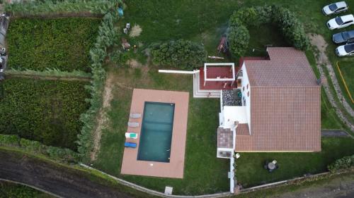 an aerial view of a house with a swimming pool at Country House in Azores - S. Miguel in Ribeira Grande