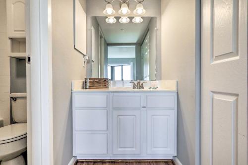 a bathroom with a sink and a mirror at Steps to Beach Scenic Condo in Ocean City! in Ocean City