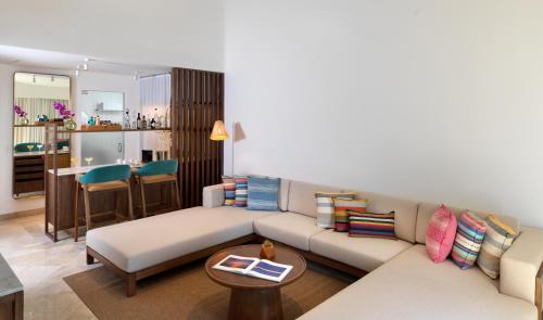 a living room with a couch and a table at ME Cabo by Meliá in Cabo San Lucas