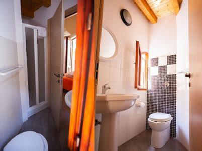 a bathroom with a white toilet and a sink at Sciabika Home - Edificio Eolie in Castellammare del Golfo