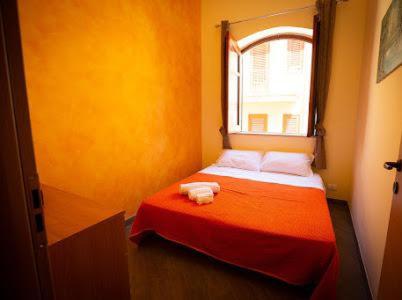 a small bedroom with a red bed with a window at Sciabika Home - Edificio Eolie in Castellammare del Golfo