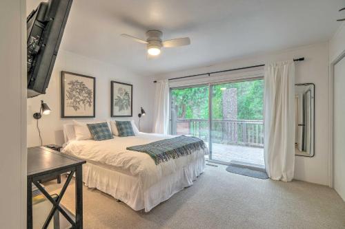 a bedroom with a bed and a large window at Cozy Retreat with Deck about 2 Mi to Pinecrest Lake! in Strawberry