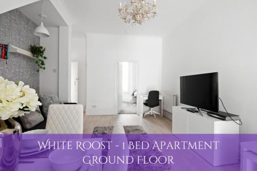 a living room with a white root i bed apartment ground floor at The Roost Group - Stylish Apartments in Gravesend