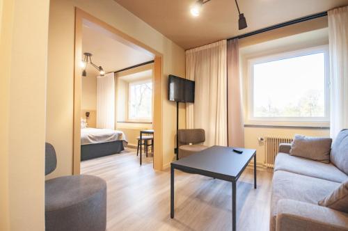 - un salon avec un canapé et une table dans l'établissement Hotel Hehrne Kök & Konferens, à Vänersborg