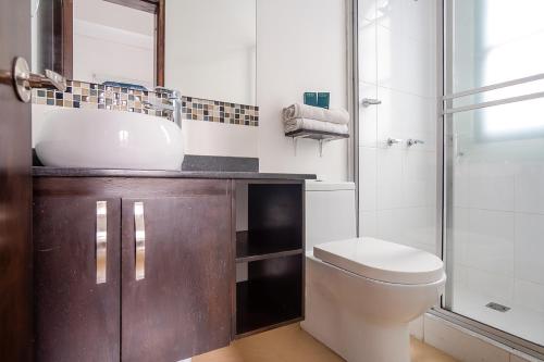 a bathroom with a sink and a toilet and a shower at Ayenda La Tua Casa in Bogotá