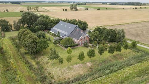 an aerial view of a house in the middle of a field at B&B de Hugt in Ulrum