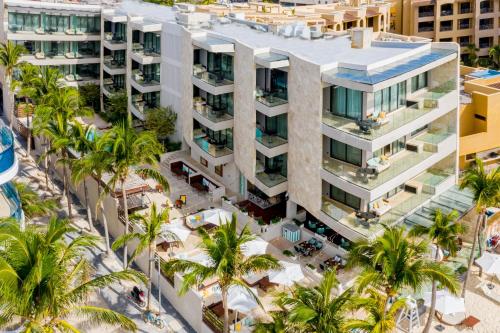 an aerial view of a building with palm trees at Thompson Playa del Carmen Beach House, part of Hyatt in Playa del Carmen