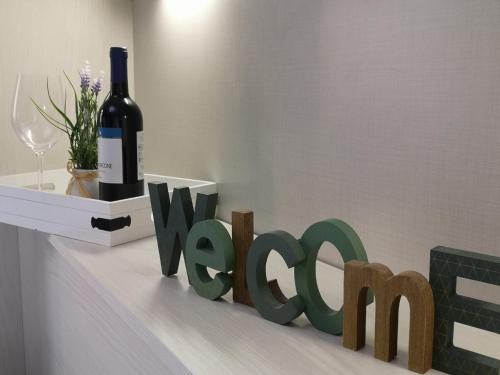 a bottle of wine and a wine sign on a counter at BGY Central Apartments in Bergamo