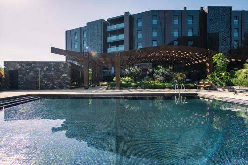 a large swimming pool in front of a building at Funchal BEAUTIFUL vista mar in Funchal