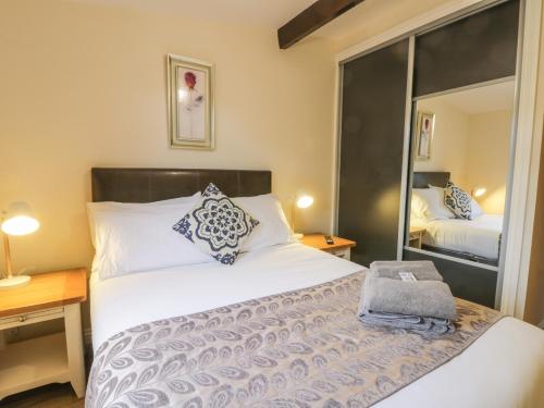 1 dormitorio con 1 cama grande y espejo en Bugle, en Saltburn-by-the-Sea
