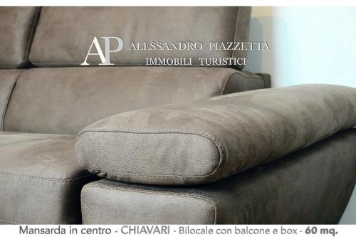 a couch with a cushion on top of it at Studio d'artista in Chiavari