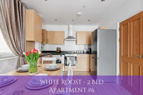 a kitchen with a white root bed apartment at The Roost Group - Bedford House Apartments in Gravesend