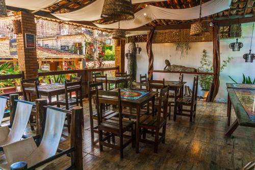 a restaurant with tables and chairs in a room at Pousada Sonho Meu in Pipa