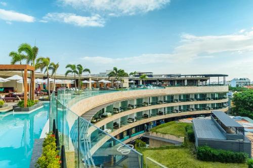 a bridge over a pool at a resort at Hyatt Centric Playa del Carmen - Downtown House & Beach House in Playa del Carmen