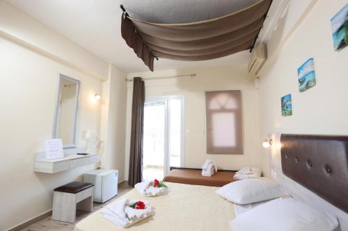 a room with two beds and a sink in it at Summer Beach Hotel in Polykhrono