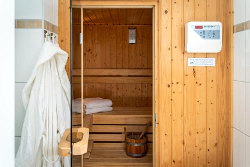 a sauna in a wooden room with a towel at Strandhaus Düne 19 - Gelassenheit in Neuhaus