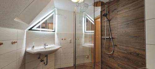 a bathroom with a sink and a shower at Ermis Apartments in Metzingen