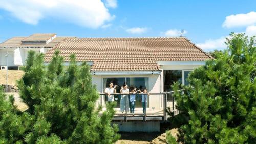 a group of people standing on a balcony of a house at YURURI - Vacation STAY 86391v in Kose