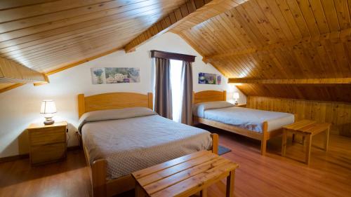 a bedroom with two beds in a room with wooden ceilings at Quinta Rico in Quatro Ribeiras