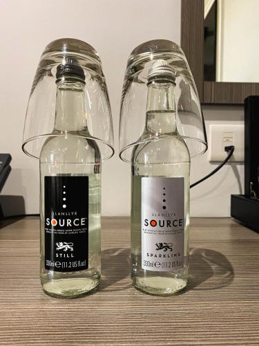 two glass bottles sitting on top of a table at Belmont Llandudno in Llandudno