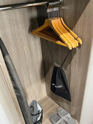 a black bag hanging on a wooden wall at Belmont Llandudno in Llandudno