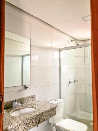 a bathroom with a toilet and a sink and a shower at Vila Sancar Pousada in Lençóis