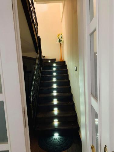 a hallway with a staircase with a vase of flowers at Casa Central Luxury in Oradea