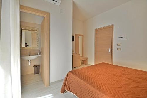 Hotel Incanto tesisinde bir odada yatak veya yataklar