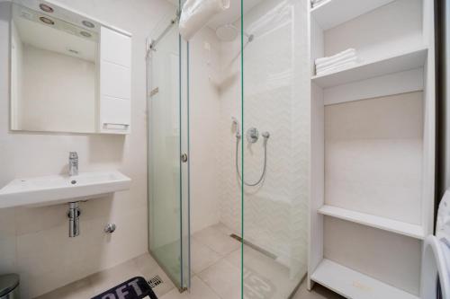 a bathroom with a shower and a sink at Soho City MK LUX Apartment in Bar