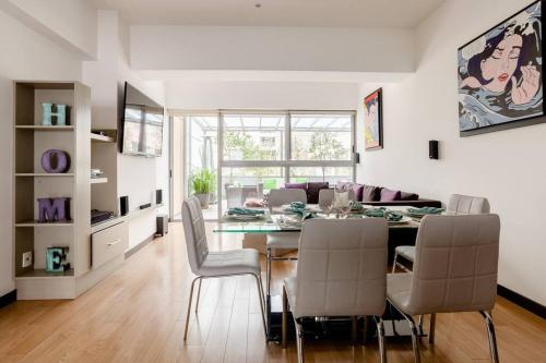 a dining room and living room with a table and chairs at Beautiful apartment in Polanco area with amenities in Mexico City