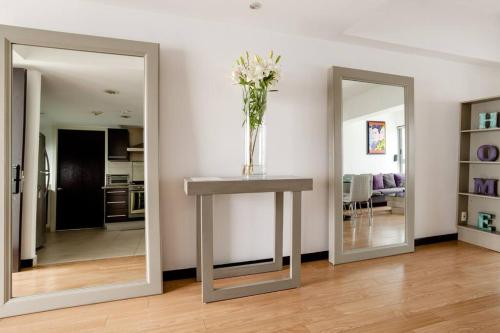 a vase of flowers on a table in a living room at Beautiful apartment in Polanco area with amenities in Mexico City